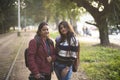 Two young Indian sisters walking in a field in winter afternoon. Royalty Free Stock Photo