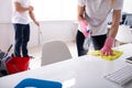 Two Young Janitor Cleaning The Office