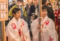 Two young Japanese Miko maiden girls dressed in traditional white shÃÂzoku kimono