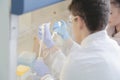 Two young Laboratory scientists working at lab with test tubes a Royalty Free Stock Photo