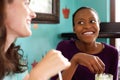 Two young ladies chatting in a cafe Royalty Free Stock Photo