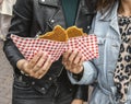 Two young ladies are holding a large dutch biscuit Royalty Free Stock Photo