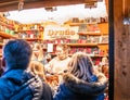 Two young ladies selling leather bound gifts at the Christmas market in the German town of Aachen