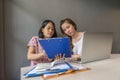 Two office ladies working on laptop and reading document report Royalty Free Stock Photo