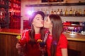 Two young lesbian girls kissing at a club party Royalty Free Stock Photo