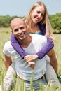 Two young lovers holding each other piggyback Royalty Free Stock Photo