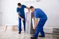 Two Male Movers Packing Furniture Royalty Free Stock Photo