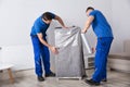 Two Male Movers Packing Furniture Royalty Free Stock Photo