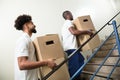 Two Young Male Worker Holding Cardboard Boxes Royalty Free Stock Photo
