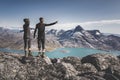 Two young man happy traveler on top of mountain in Greenland, Nuuk. nature mountain landscape aerial drone photo showing