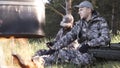 Two young man hunters near forest. Summer vacation forest. Friends sit at forest picnic. Best friends spend leisure