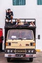 Two young man on top of their truck in Denpasar, Bali Indonesia