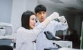 Two young medical scientist looking at test tube in medical laboratory , select focus on male scientist