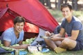 Two Young Men Cooking On Camping Stove Outside Tent Royalty Free Stock Photo