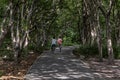 Two young men enjoying a bike ride on a sunny day in a city park. Healthcare Concept.