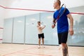 Two young men, friends playing squash together on squash court. Competition and leisure Royalty Free Stock Photo