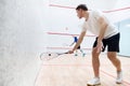 Two young men, friends playing squash together on squash court. Competition and leisure Royalty Free Stock Photo