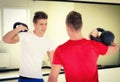 Two young men in gym working out with kettlebells Royalty Free Stock Photo