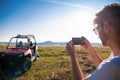 Two young men having fun while driving a off road buggy car Royalty Free Stock Photo