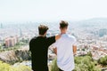 Two young men looking at the views form the top of a mountain. Royalty Free Stock Photo