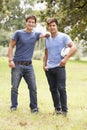 Two Young Men Playing With Rugby Ball In Countryside Royalty Free Stock Photo