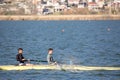 Two young men practicing kayaking in a lake