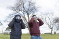 Two young men prepared with protective glasses to view a total solar eclipse