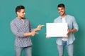 Two smiling men in casual clothing showing white blank board Royalty Free Stock Photo