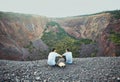 Two young men sitting on rocky cliff Royalty Free Stock Photo