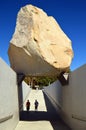 Two young men stand under Levitated Mass Royalty Free Stock Photo