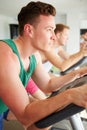 Two Young Men Training In Gym On Cycling Machines Together Royalty Free Stock Photo