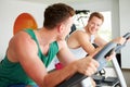 Two Young Men Training In Gym On Cycling Machines Together Royalty Free Stock Photo