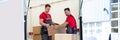 Young Men Stacking The Cardboard Boxes In Moving Truck Royalty Free Stock Photo