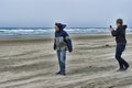 Two young men on a windy beach