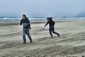 Two young men on a windy beach