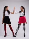 Two young models in funny outfit giving high-five Royalty Free Stock Photo