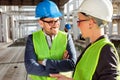 Two young modern architects or civil engineers talking about future project development on a construction site Royalty Free Stock Photo