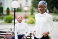 Two young modern fashionable, attractive, tall and slim african muslim womans in hijab or turban head scarf posed together Royalty Free Stock Photo