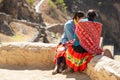 Two young native Andean ladies looking at the Sacred Valley in Cusco, Peru, South America