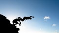 Two young natives, in silhouette, are jumping from the Porto da Barra pier in the city of Salvador, Bahia