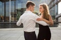 Two young people dancing tango outside on city embankment Royalty Free Stock Photo