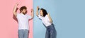 Portrait of young emotive man and girl shouting each other isolated on blue and pink trendy color background. Human Royalty Free Stock Photo