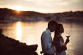 Two young people enjoying a glass of red wine in the sunset on the seaside.Healthy glass od homemade red wine,Mediterranean Royalty Free Stock Photo