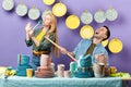 Two young people enjoying singing in the kitchen Royalty Free Stock Photo