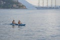 Two young people are floating in sea tandem kayak. Sea kayaking