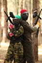 Two young people playing paintball Royalty Free Stock Photo