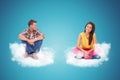 Two young people sitting and resting on couds Royalty Free Stock Photo