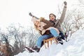 Two young people sliding on a sled Royalty Free Stock Photo