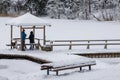 Two young people in the snow-covered gazebo