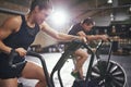 Two young people training toughly on simulators Royalty Free Stock Photo